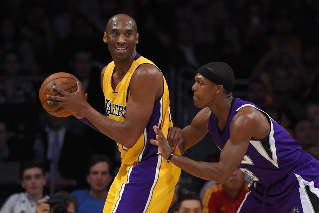 Los Angeles Lakers forward Kobe Bryant, left, smiles as Sacramento Kings guard Rajon Rondo defends during the first half of an NBA basketball game, Wednesday, Jan. 20, 2016, in Los Angeles. (AP Photo/Mark J. Terrill)