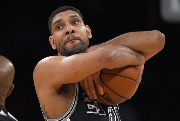 San Antonio Spurs center Tim Duncan hugs the ball prior to the Spurs' NBA basketball game against the Los Angeles Lakers, Friday, Jan. 22, 2016, in Los Angeles. (AP Photo/Mark J. Terrill)