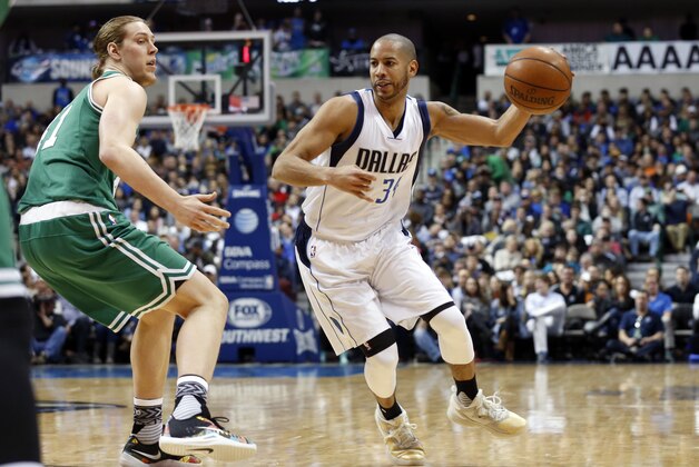 Boston Celtics forward Kelly Olynyk (41) defends as Dallas Mavericks guard Devin Harris (34) controls the ball during the first half of an NBA basketball game, Monday, Jan. 18, 2016, in Dallas. (AP Photo/Sharon Ellman)