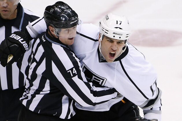 Los Angeles Kings' Milan Lucic (17) shouts at referee Brad Meier (34) as Lucic is restrained by linesman Lonnie Cameron (74) after Lucic earned a roughing penalty and a game misconduct during the third period of an NHL hockey game against the Arizona Coyotes on Saturday, Jan. 23, 2016, in Glendale, Ariz. The Coyotes defeated the Kings 3-2. (AP Photo/Ross D. Franklin)