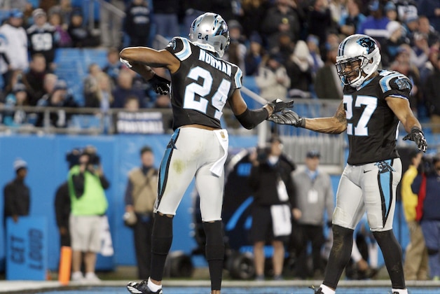 Carolina Panthers' Josh Norman (24) celebrates with teammate Robert McClain (27) after stopping the Tampa Bay Buccaneers at the goal line during the second half of an NFL football game in Charlotte, N.C., Sunday, Jan. 3, 2016. The Panthers won 38-10. (AP Photo/Bob Leverone)