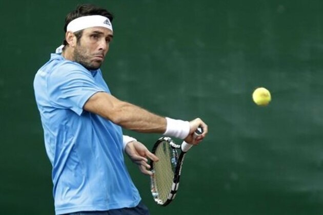 CORRECTS TO DAVID MARRERO, INSTEAD OF FERNANDO VERDASCO - Spain's David Marrero returns a shot to the Bryan brothers, Bob and Mike, in the men's doubles final at the U.S. Men's Clay Court Championship tennis tournament, Saturday, April 12, 2014, in Houston. (AP Photo/Pat Sullivan)