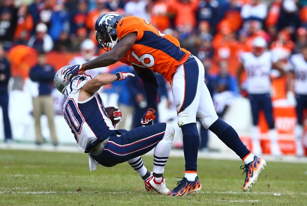Jan 24, 2016; Denver, CO, USA; New England Patriots wide receiver Danny Amendola (80) is hit by Denver Broncos free safety Darian Stewart (26) after a catch in the third quarter in the AFC Championship football game at Sports Authority Field at Mile High. Mandatory Credit: Mark J. Rebilas-USA TODAY Sports