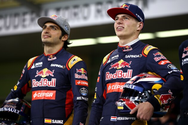 ABU DHABI, UNITED ARAB EMIRATES - NOVEMBER 26:  Max Verstappen of Netherlands and Scuderia Toro Rosso poses with Carlos Sainz of Spain and Scuderia Toro Rosso in the pit lane for a team photograph during previews for the Abu Dhabi Formula One Grand Prix at Yas Marina Circuit on November 26, 2015 in Abu Dhabi, United Arab Emirates.  (Photo by Mark Thompson/Getty Images)