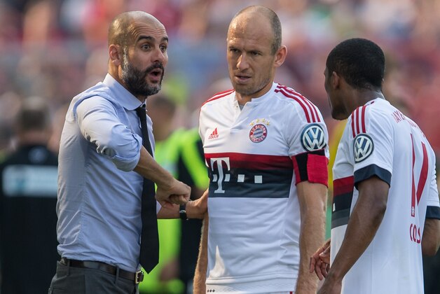 Munich's coach Pep Guardiola, left, addresses Arjen Robben, center, and Douglas Costa de Souza during the German soccer cup first round match between fifth tier team FC Noettingen and Bayern Munich in Karlsruhe, southern Germany, Sunday, Aug. 9, 2015. (AP Photo/Daniel Maurer)