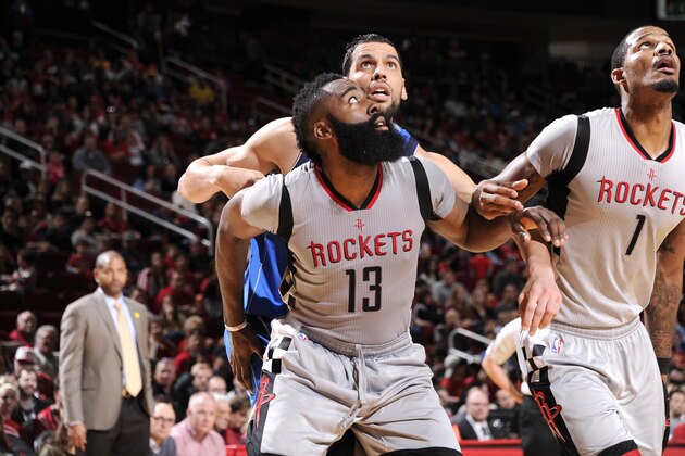 HOUSTON, TX - JANUARY 24: James Harden #13 of the Houston Rockets boxes out against Salah Mejri #50 of the Dallas Mavericks during the game on January 24, 2016 at the Toyota Center in Houston, Texas. NOTE TO USER: User expressly acknowledges and agrees that, by downloading and or using this photograph, User is consenting to the terms and conditions of the Getty Images License Agreement. Mandatory Copyright Notice: Copyright 2016 NBAE (Photo by Bill Baptist/NBAE via Getty Images)