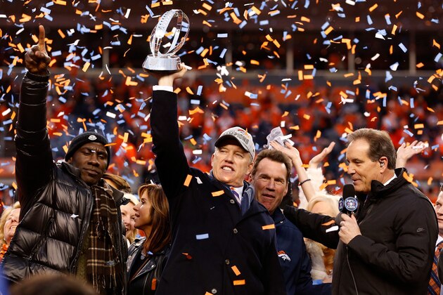 DENVER, CO - JANUARY 24:  General Manager and Executive Vice President of Football Operation for the Denver Broncos John Elway holds up the Lamar Hunt Trophy with former Bronco Terrell Davis after defeating the New England Patriots in the AFC Championship game at Sports Authority Field at Mile High on January 24, 2016 in Denver, Colorado. The Broncos defeated the Patriots 20-18.  (Photo by Christian Petersen/Getty Images)