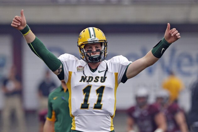 North Dakota State quarterback Carson Wentz (11) warms up before the start of their NCAA college football game against Montana Saturday, Aug. 29, 2015, in Missoula, in Mont.  (AP Photo/Rick Bowmer)