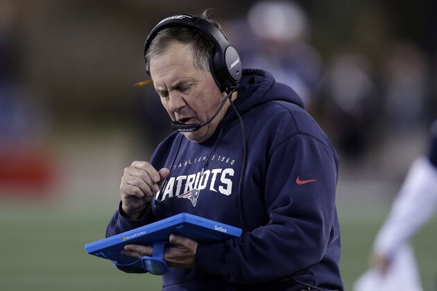 New England Patriots head coach Bill Belichick studies a tablet device along the sideline during the first half of an NFL football game against the Philadelphia Eagles, Sunday, Dec. 6, 2015, in Foxborough, Mass. (AP Photo/Charles Krupa)