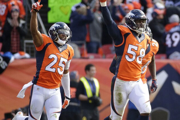 Denver Broncos outside linebacker Von Miller (58) celebrates after intercepting a pass from New England Patriots quarterback Tom Brady during the first half the NFL football AFC Championship game between the Denver Broncos and the New England Patriots, Sunday, Jan. 24, 2016, in Denver. At left is Denver Broncos cornerback Chris Harris. (AP Photo/Charlie Riedel)