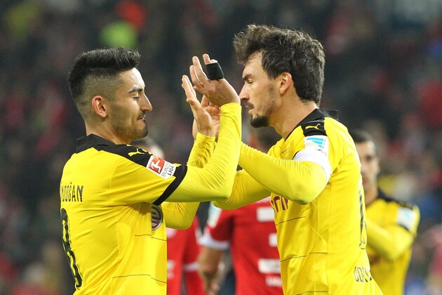 Dortmund's midfielder Ilkay Guendogan (L) and Dortmund's defender Mats Hummels celebrate after the German first division Bundesliga football match FSV Mainz 05 vs Borussia Dortmund in Mainz, western Germany, on October 16, 2015. Dortmund won the match 0-2.    AFP PHOTO / DANIEL ROLAND

RESTRICTIONS: DURING MATCH TIME: DFL RULES TO LIMIT THE ONLINE USAGE TO 15 PICTURES PER MATCH AND FORBIDS IMAGE SEQUENCES TO SIMULATE VIDEO. 
== RESTRICTED TO EDITORIAL USE ==
FOR FURTHER QUERIES PLEASE CONTACT DFL DIRECTLY AT + 49 69 650050.        (Photo credit should read DANIEL ROLAND/AFP/Getty Images)