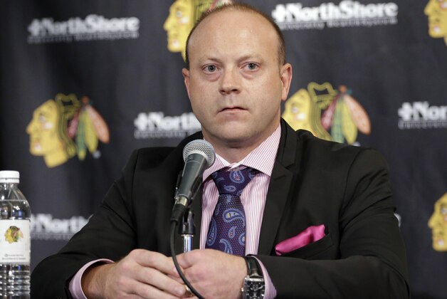 Chicago Blackhawks Vice President/General Manager Stan Bowman, listens to the media during a news conference at the United Center in Chicago, Wednesday, July 16, 2014. The Blackhawks recently agreed to eight-year contract extensions with Toews and Kane. (AP Photo/Nam Y. Huh)