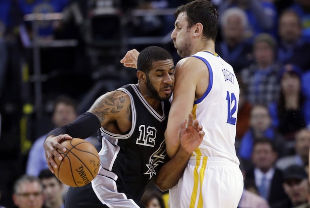 San Antonio Spurs' LaMarcus Aldridge (12) collides with Golden State Warriors' Andrew Bogut (12) during the first half of an NBA basketball game Monday, Jan. 25, 2016, in Oakland, Calif. (AP Photo/Marcio Jose Sanchez)