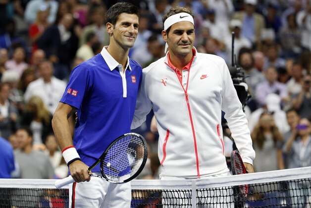 Novak Djokovic, of Serbia, left, and Roger Federer, of Switzerland, pose for photos before the start of the men's championship match of the U.S. Open tennis tournament, Sunday, Sept. 13, 2015, in New York. (AP Photo/Julio Cortez)