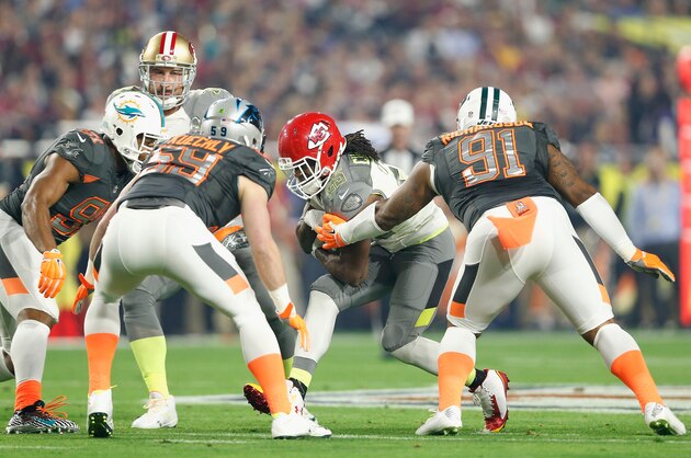GLENDALE, AZ - JANUARY 25: Team Carter running back Jamaal Charles #25 of the Kansas City Chiefs is hit by Team Irvin defensive end Cameron Wake #91 of the Indianapolis Colts (right) and inside linebacker Luke Kuechly #59 of the Carolina Panthers (left) during the first half of the 2015 Pro Bowl at University of Phoenix Stadium on January 25, 2015 in Glendale, Arizona.  (Photo by Christian Petersen/Getty Images)