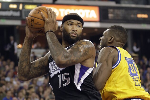 Sacramento Kings forward DeMarcus Cousins, left, pulls a rebound away from Golden State Warriors center Festus Ezeli, of Nigeria, during the first quarter of an NBA basketball game Saturday, Jan. 9, 2016, in Sacramento, Calif. The Warriors won 128-116.(AP Photo/Rich Pedroncelli)