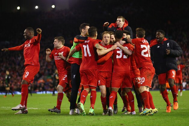 LIVERPOOL, ENGLAND - JANUARY 26:  Joe Allen of Liverpool (24) is congratulated by team mates as he scores the decisive penalty in the shoot out during the Capital One Cup semi final second leg match between Liverpool and Stoke City at Anfield on January 26, 2016 in Liverpool, England. Liverpool win 6-5 on penalties after extra time.  (Photo by Clive Brunskill/Getty Images)