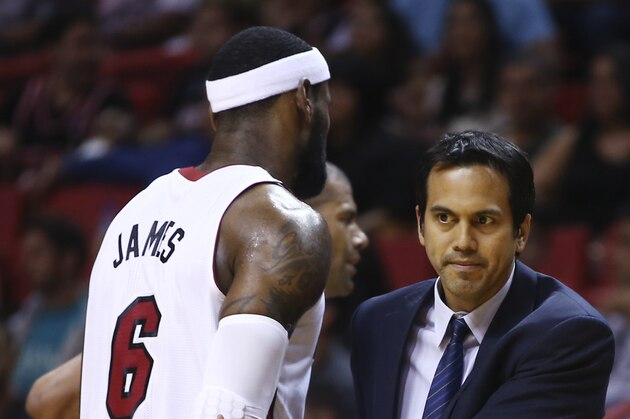 Miami Heat's LeBron James (6) walks past coach Erik Spoelstra after James was charged with an offensive foul against the Washington Wizards during the first half of an NBA  basketball game, Monday, March 10, 2014, in Miami. (AP Photo/J Pat Carter)