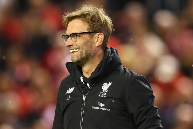 LIVERPOOL, ENGLAND - JANUARY 26:  Jurgen Klopp manager of Liverpool smiels after victory in the penalty shoot out after the Capital One Cup semi final second leg match between Liverpool and Stoke City at Anfield on January 26, 2016 in Liverpool, England. Liverpool win 6-5 on penalties after extra time.  (Photo by Clive Brunskill/Getty Images)