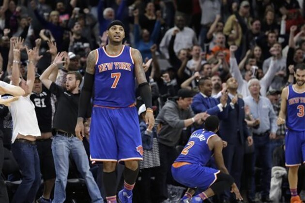 New York Knicks forward Carmelo Anthony (7) walks off the court after teammate Jose Calderon (3) missed a last-second shoot against the San Antonio Spurs during the second half of an NBA basketball game Friday, Jan. 8, 2016, in San Antonio. San Antonio won 100-99. (AP Photo/Eric Gay)