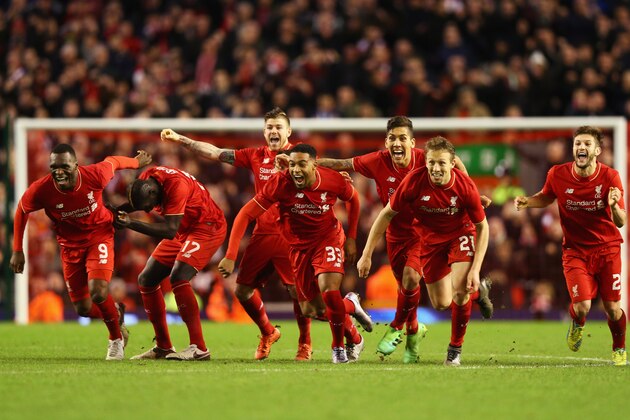 LIVERPOOL, ENGLAND - JANUARY 26:  Liverpool players celebrate as Joe Allen of Liverpool scores the decisive penalty in the shoot out during the Capital One Cup semi final second leg match between Liverpool and Stoke City at Anfield on January 26, 2016 in Liverpool, England. Liverpool win 6-5 on penalties after extra time.  (Photo by Clive Brunskill/Getty Images)