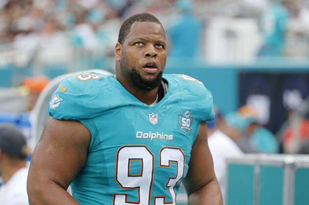 Miami Dolphins defensive tackle Ndamukong Suh (93) walks the sidelines during the first half of an NFL football game against the New England Patriots, Sunday, Jan. 3, 2016 in Miami Gardens, Fla. (AP Photo/Wilfredo Lee)