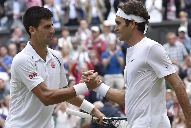 Novak Djokovic of Serbia, left, shakes hands with Roger Federer of Switzerland after winning the men's singles final at the All England Lawn Tennis Championships in Wimbledon, London, Sunday July 12, 2015. Djokovic won the match 7-6, 6-7, 6-4, 6-3.  (Toby Melville/Pool Photo via AP)