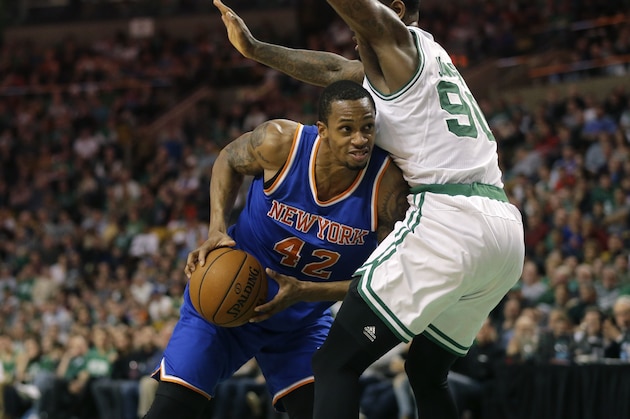 New York Knicks forward Lance Thomas (42) tries to drive past Boston Celtics forward Amir Johnson (90) in the fourth quarter of an NBA basketball game Sunday, Dec. 27, 2015, in Boston. The Celtics won 100-91. (AP Photo/Steven Senne)