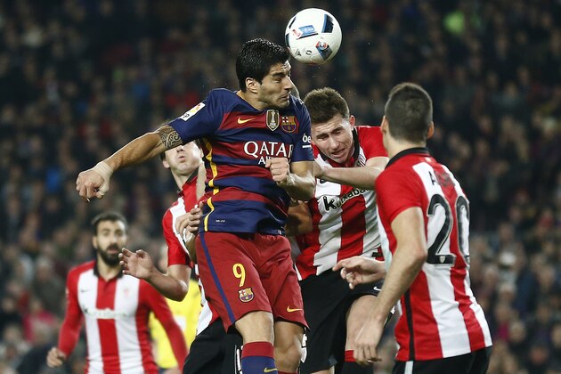 FC Barcelona's Luis Suarez, left, heads for the ball against Athletic Bilbao's Aymeric Laporte, second right, during a quarterfinal, second leg, Copa del Rey soccer match at the Camp Nou stadium in Barcelona, Spain, Wednesday, Jan. 27, 2016. (AP Photo/Manu Fernandez)