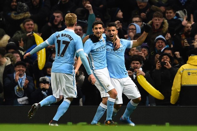 MANCHESTER, ENGLAND - JANUARY 27:  (R-L) Sergio Aguero of Manchester City is congratulated by teammates David Silva and Kevin De Bruyne of Manchester City after scoring his team's third goal during the Capital One Cup Semi Final, second leg match between Manchester City and Everton at the Etihad Stadium on January 27, 2016 in Manchester, England.  (Photo by Laurence Griffiths/Getty Images)