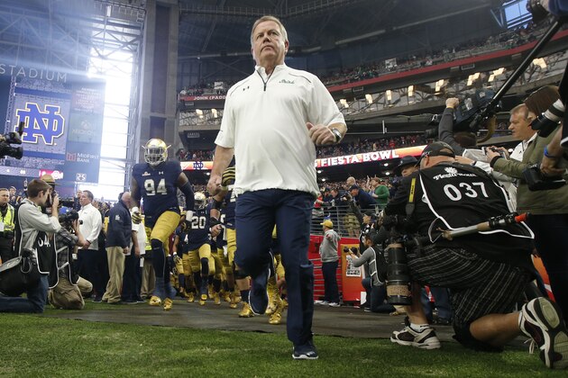 Notre Dame head coach Brian Kelly leads his players onto the field prior to the Fiesta Bowl NCAA College football game against Ohio State , Friday, Jan. 1, 2016, in Glendale, Ariz.  (AP Photo/Ross D. Franklin)