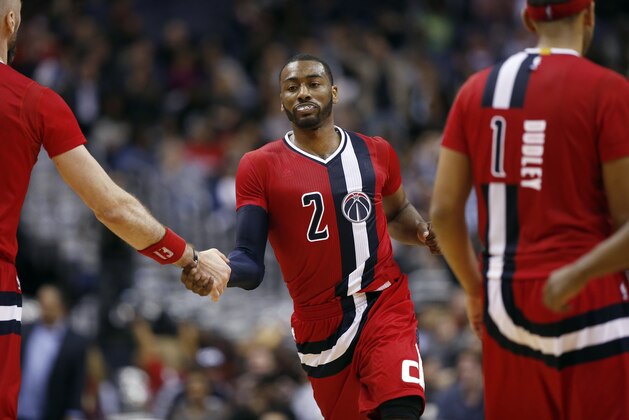 Washington Wizards guard John Wall (2) celebrates a play with Washington Wizards center Marcin Gortat, left, from Poland,in the second half of an NBA basketball game against the Boston Celtics, Saturday, Jan. 16, 2016, in Washington. The Celtics won 119-117. (AP Photo/Alex Brandon)