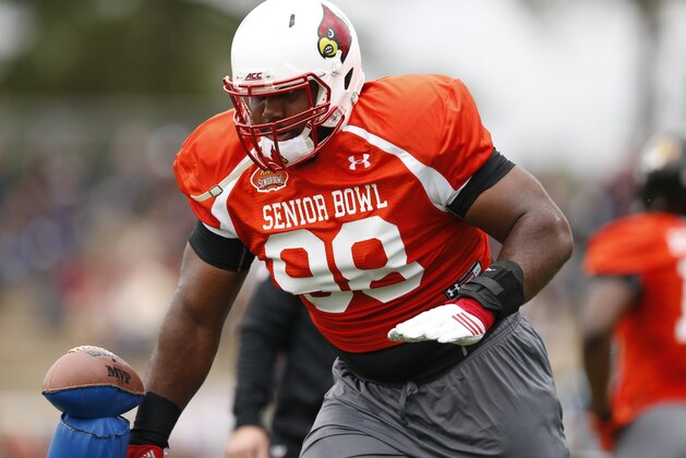 Louisville defensive end Sheldon Rankins (98) runs through drills during NCAA college football practice for the Senior Bowl, Tuesday, Jan. 26, 2016, at Fairhope Municipal Stadium, in Fairhope, Ala.(AP Photo/Brynn Anderson)