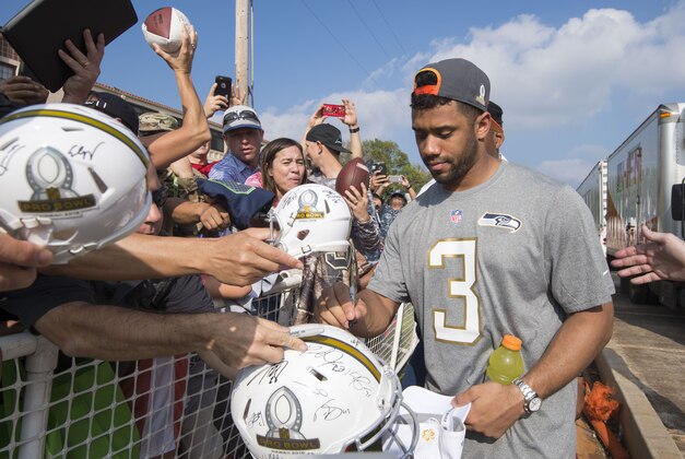 January 27, 2016; Wahiawa, HI, USA; Seattle Seahawks quarterback Russell Wilson (3) signs autographs during the 2016 Pro Bowl Draft at Wheeler Army Airfield. Mandatory Credit: Kyle Terada-USA TODAY Sports
