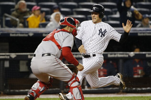 New York Yankees John Ryan Murphy scores on Brendan Ryan's second-inning, RBI single ahead of the throw to Boston Red Sox catcher Sandy Leon in a baseball game in New York, Thursday, Oct. 1, 2015.   (AP Photo/Kathy Willens)