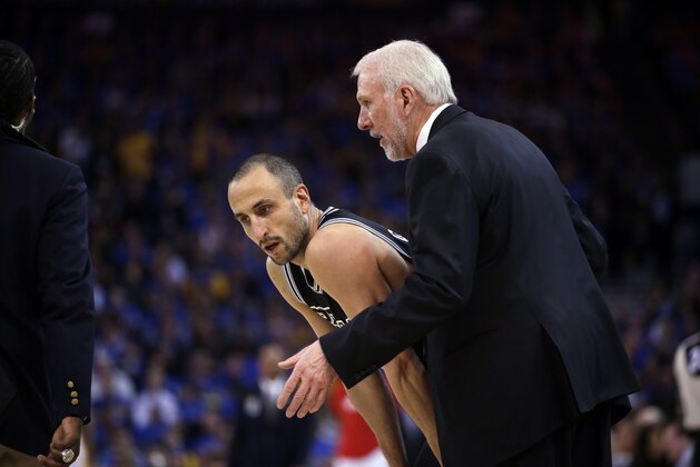 San Antonio Spurs head coach Gregg Popovich, right, talks to guard Manu Ginobili  during an NBA basketball game against the Golden State Warriors Monday, Jan. 25, 2016, in Oakland, Calif. (AP Photo/Marcio Jose Sanchez)