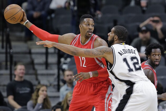Houston Rockets center Dwight Howard, left,  and San Antonio Spurs forward LaMarcus Aldridge, right, during the second half of an NBA basketball game, Wednesday, Jan. 27, 2016, in San Antonio. (AP Photo/Eric Gay)