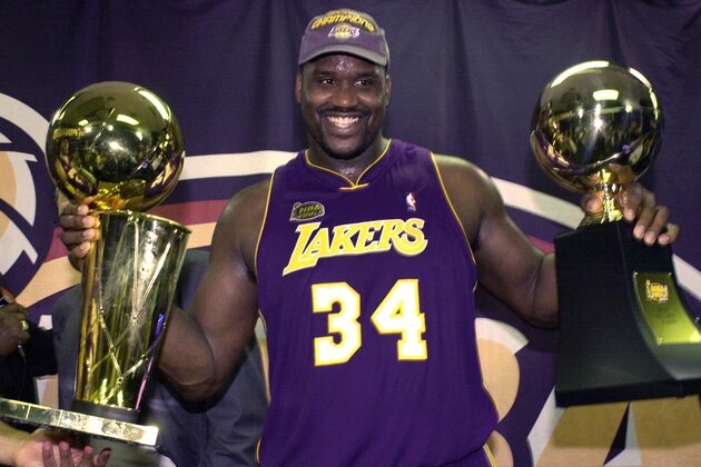 FILE- In this June 15, 2001 file photo, Los Angeles Lakers' Shaquille O'Neal holding up the MVP trophy, right, and the championship trophy after the Lakers won their second straight NBA championship in Philadelphia.  O'Neal annoucned on Twitter on Wednesday, June 1, 2011, that he's