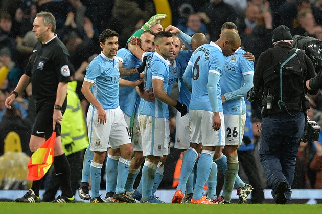 Manchester City's Argentinian striker Sergio Aguero (C) celebrates with teammates following the final whistle during the English League Cup semi-final second leg football match between Manchester City and Everton the Etihad Stadium in Manchester, north west England, on January 27, 2016.
Manchester City won the match 3-1. / AFP / Paul Ellis / RESTRICTED TO EDITORIAL USE. No use with unauthorized audio, video, data, fixture lists, club/league logos or 'live' services. Online in-match use limited to 75 images, no video emulation. No use in betting, games or single club/league/player publications.  /         (Photo credit should read PAUL ELLIS/AFP/Getty Images)