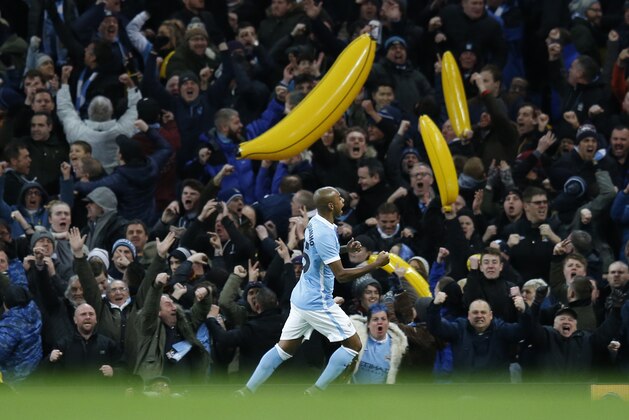 Manchester City's Fernandinho celebrates scoring his side's first goal as his teams fans celebrate with inflatable bananas during the English League Cup semifinal second leg soccer match between Manchester City and Everton at the City of Manchester Stadium in Manchester, England, Wednesday, Jan. 27, 2016. (AP Photo/Jon Super)