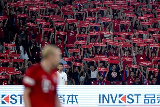 Fans of Bayern Munich hold banner during a friendly football match between Bayern Munich and Valencia at the Bird's Nest stadium in Beijing on July 18, 2015.      AFP PHOTO / WANG ZHAO        (Photo credit should read WANG ZHAO/AFP/Getty Images)