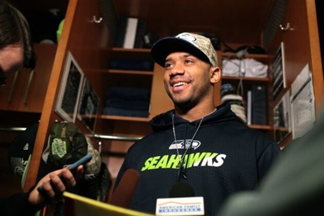 Seattle Seahawks Quarterback Russell Wilson talks to the press at his space in the team locker room, Monday, Jan. 18, 2016, in Renton, Wash. The Seahawks' season ended Sunday, Jan. 17, 2016, with a loss to the Carolina Panthers in an NFL football divisional playoff game. (AP Photo/Meryl Schenker)