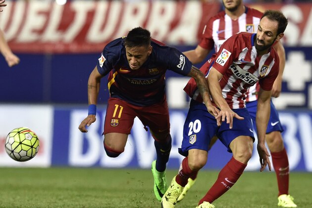 Barcelona's Brazilian forward Neymar (L) vies with Atletico Madrid's defender Juanfran during the Spanish league football match Club Atletico de Madrid vs FC Barcelona at the Vicente Calderon stadium in Madrid on September 12, 2015.   AFP PHOTO/ GERARD JULIEN        (Photo credit should read GERARD JULIEN/AFP/Getty Images)