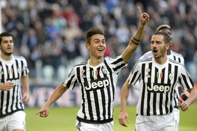 Juventus' Paulo Dybala celebrates with is teammates after scoring during a Serie A soccer match between Juventus and Verona at the Juventus stadium, in Turin, Italy, Wednesday, Jan 6, 2016. (AP Photo/ Massimo Pinca)