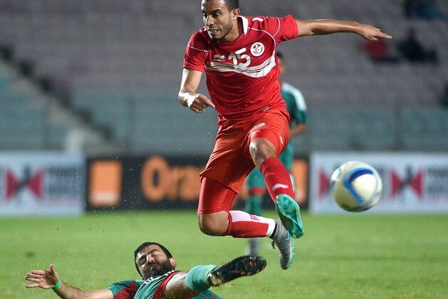 Tunisian Mohamed Ali Monsser (top) vies for the ball with Morocco's defender Rachid Tiberkanine during an African Nations Championship (CHAN) qualifying match on October 25, 2015 in Rades. Both Tunisia and Morocco have already quallified for the 16-nation tournament, which Rwanda host in January and February. AFP PHOTO / FETHI BELAID        (Photo credit should read FETHI BELAID/AFP/Getty Images)