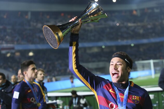 FC Barcelona’s Neymar holds up the trophy as he celebrates winning the final match against River Plate at the FIFA Club World Cup soccer tournament in Yokohama, near Tokyo, Sunday, Dec. 20, 2015. FC Barcelona beat River Plate 3-0. (AP Photo/Eugene Hoshiko)