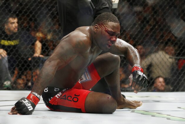 Anthony Johnson sits on the mat after the second round in a light heavyweight title mixed martial arts bout against Daniel Cormier at UFC 187 on Saturday, May 23, 2015, in Las Vegas. (AP Photo/John Locher)
