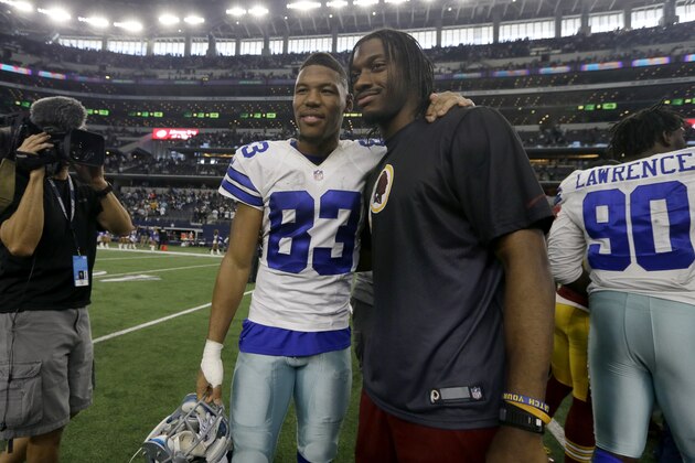 Former college teammates, Dallas Cowboys' Terrance Williams (83) and Washington Redskins' Robert Griffin III, pose for a photo after their NFL football game, Sunday, Jan. 3, 2016, in Arlington, Texas. The played at Baylor University. (AP Photo/Tim Sharp)