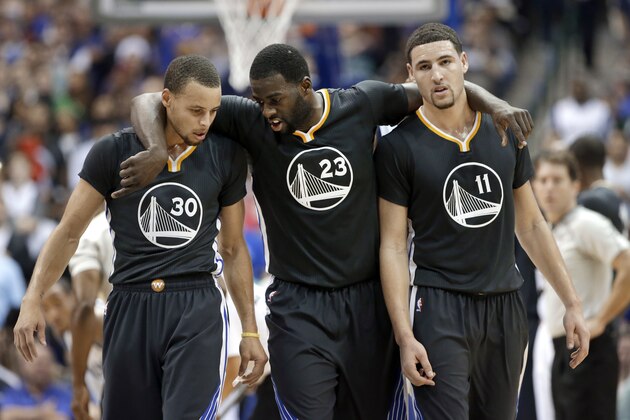 Golden State Warriors guard Stephen Curry (30), Draymond Green (23) and Klay Thompson (11) walk up court during the second half of an NBA basketball game against the Dallas Mavericks, Saturday, Dec. 13, 2014, in Dallas. Curry had 29-points, Green had 20-points and Thompson had 25-points in the 105-98 Warriors win. (AP Photo/Tony Gutierrez)