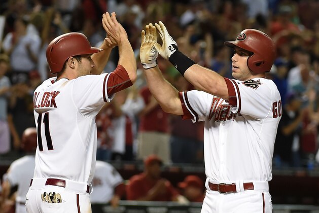 PHOENIX, AZ - MAY 22:  Paul Goldschmidt #44 and teammate A.J. Pollock #11 of the Arizona Diamondbacks celebrate a game tying two run home run in the tenth inning against the Chicago Cubs at Chase Field on May 22, 2015 in Phoenix, Arizona.  (Photo by Norm Hall/Getty Images)
